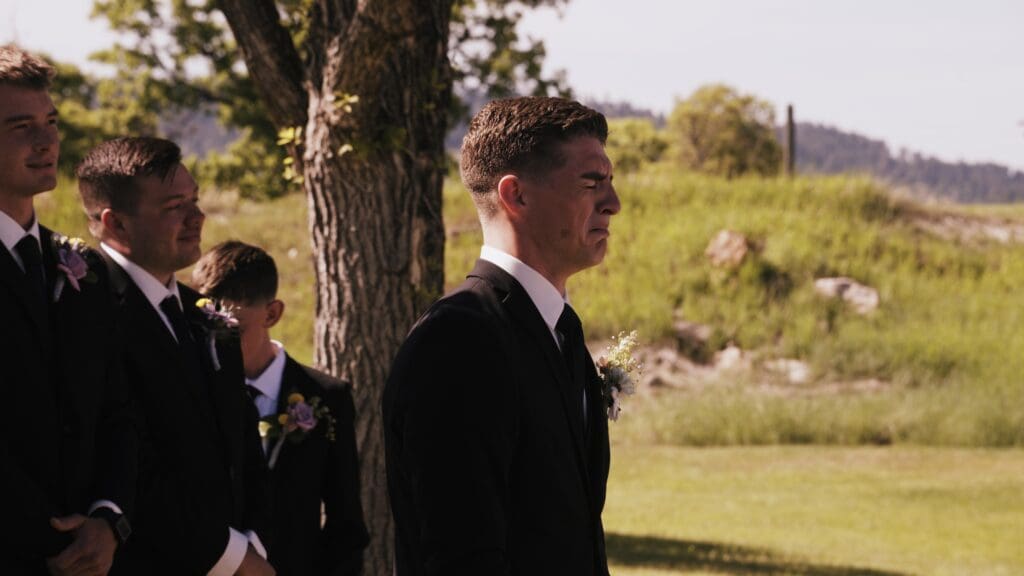 A groom crying when he sees his bride walking down the aisle during their wedding in the Black Hills, South Dakota